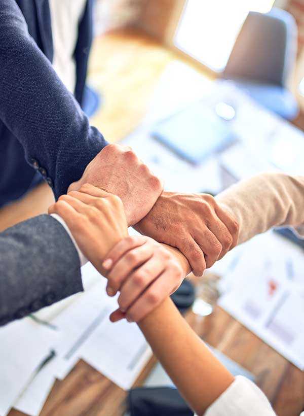 a team members holding their hands